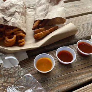a bag of fries and dipping sauces