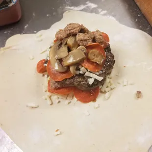an uncooked hamburger on a roll