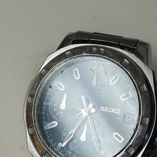 Scratched up and chipped front glass of my watch.