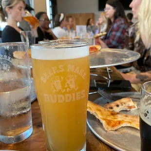 people eating pizza and drinking beer