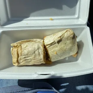 a burrito in a styrofoam container