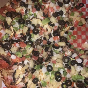 a pizza with olives and peppers