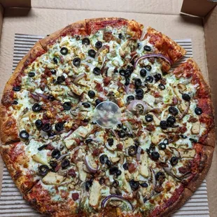 Custom pizza - tomato sauce, chicken, black olives, onion, bacon. Asked for pesto sauce too.