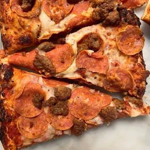 slices of pepperoni and sausage pizza