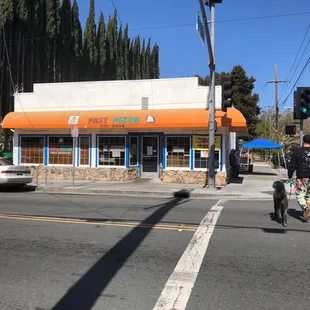 a man riding a motorcycle in front of a fast food restaurant