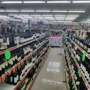 a wide aisle of wine bottles