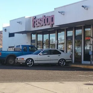 two cars parked in front of a fast food restaurant