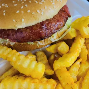 a hamburger and fries on a styrofoam tray