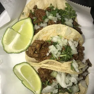 three tacos on a paper plate