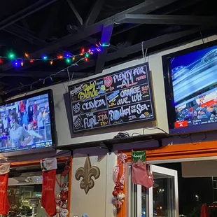 T.V.&apos;s on wall behind the bar.