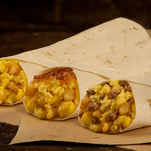 three burritos on a piece of paper