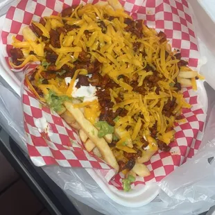 Alpastor Fries includes meat,guacamole ,sourcream, &amp; chesse