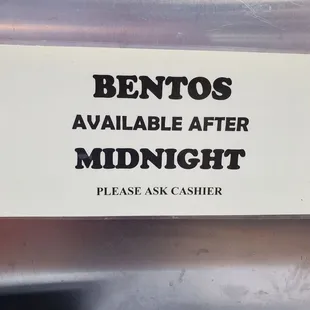 a sign that reads bentos available after midnight please ask cashier