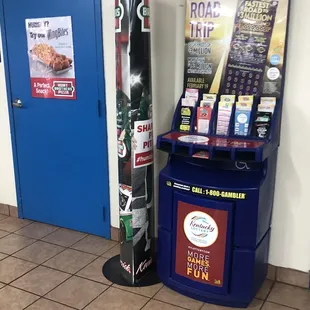 a blue trash can and a sign