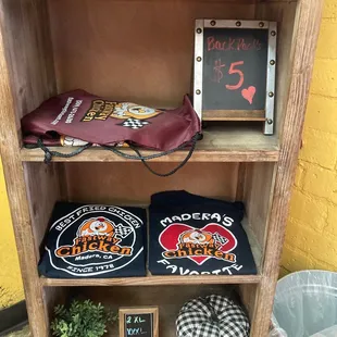 a shelf of t - shirts