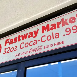 a coca cola sign above a window