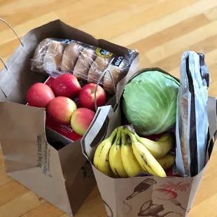a paper bag full of fruit and vegetables