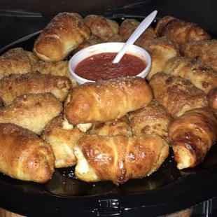a platter of croissants and sauce