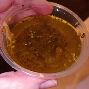 a person holding a bowl of soup