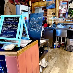 a kitchen with a menu on the counter