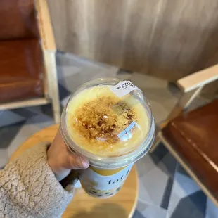 a person holding a cup of coffee