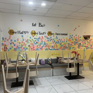 the seating area with sticky notes on the wall