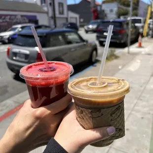 a person holding two cups of coffee
