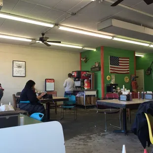 The inside of Fat Boys BBQ, featuring one very large flag, and some Bible scriptures, alongside the soda fountain and sweet tea.