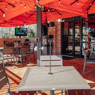 tables and chairs under an umbrella