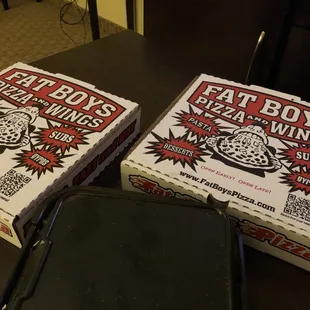 two pizza boxes on a table