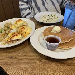"3" Point Conversion Benedict with potatoes, side of biscuits and gravy, and a side of pancakes.