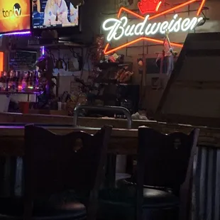 a bar with a neon budweiser sign