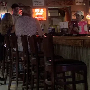 a group of people sitting at a bar