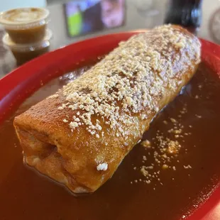 Wet carne asada burrito with red sauce
