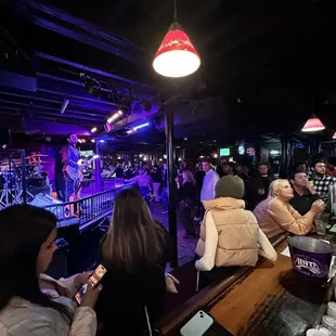 a group of people sitting at a bar