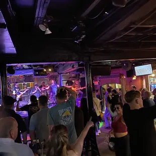 a group of people dancing in a bar