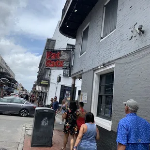 a group of people walking down the sidewalk