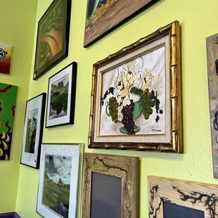 a wall of framed art