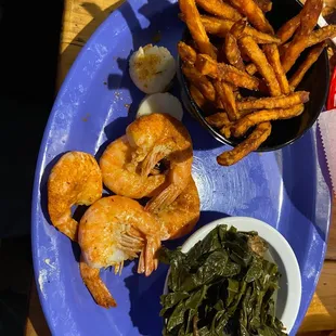 Shrimp, scallops, sweet potato fries, and collard greens