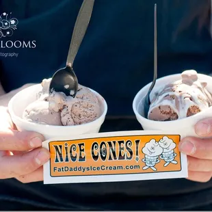 a man holding two bowls of ice cream