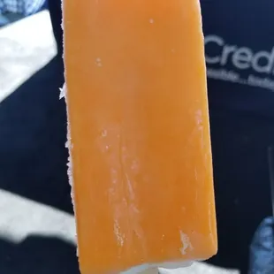 a hand holding a popsicle