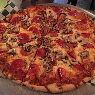 a pizza with pepperoni and mushrooms