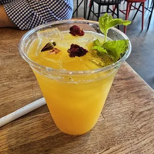 a drink in a plastic cup on a wooden table