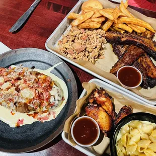Jumbo potato with bacon and cheese, brisket, pulled chicken, fries, wings, side of Mac and cheese.