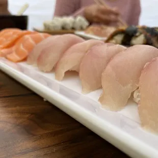 a long white plate of sushi