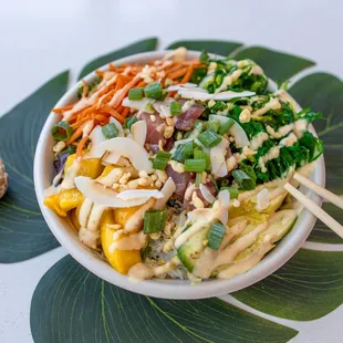a bowl of food with chopsticks