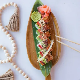 a plate of sushi and chopsticks