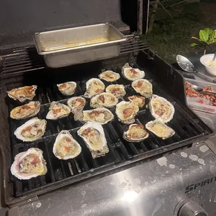 oysters being cooked on a grill