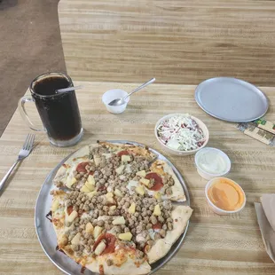 Pineapple, pepperoni, and sausage pizza with a root beer no ice.