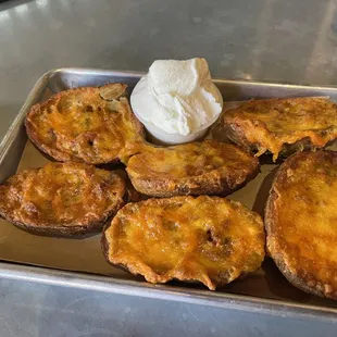 POTATO SKINS - Bacon and Cheddar. Served with Sour Cream